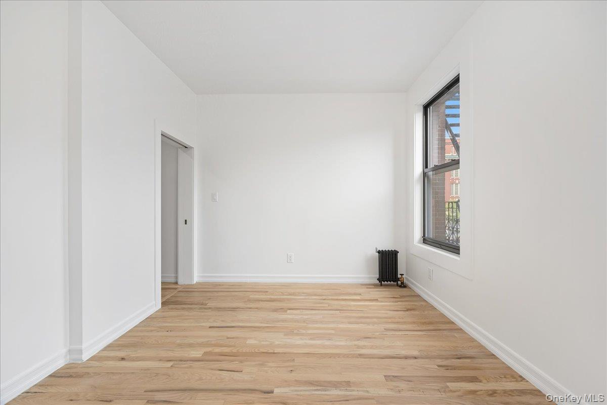 160 Wadsworth Avenue, Unit 302 Manhattan, NY 10033 - Photo 12 of 21 a view of a room with wooden floor and window