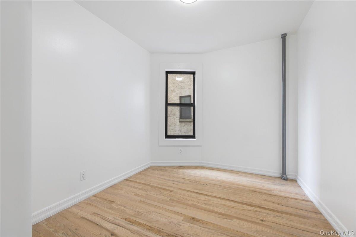 160 Wadsworth Avenue, Unit 302 Manhattan, NY 10033 - Photo 13 of 21 a view of empty room with wooden floor