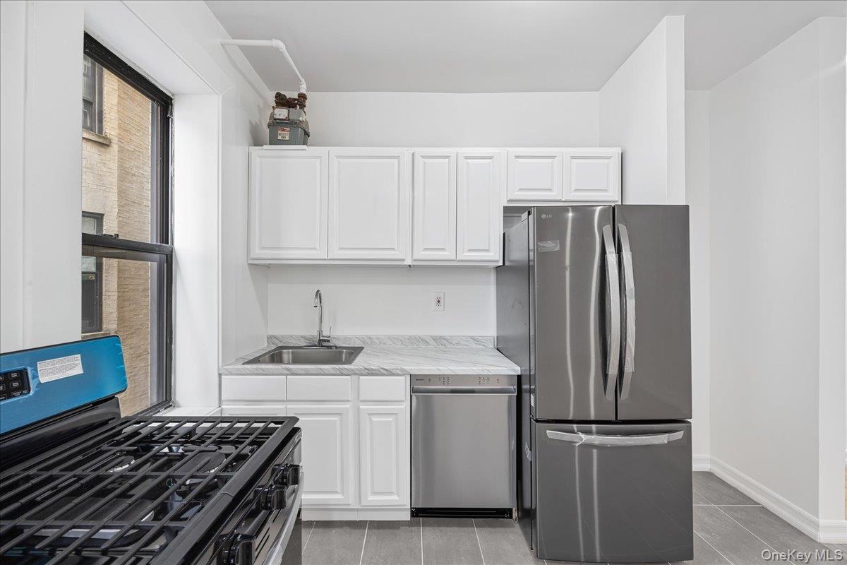 160 Wadsworth Avenue, Unit 302 Manhattan, NY 10033 - Photo 8 of 21 a kitchen with a refrigerator and a stove