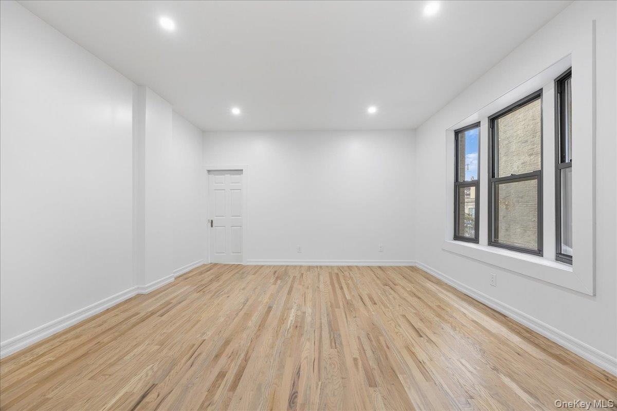 160 Wadsworth Avenue, Unit 302 Manhattan, NY 10033 - Photo 9 of 21 a view of an empty room with wooden floor and a window