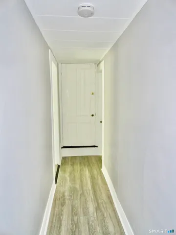 a view of hallway with wooden floor
