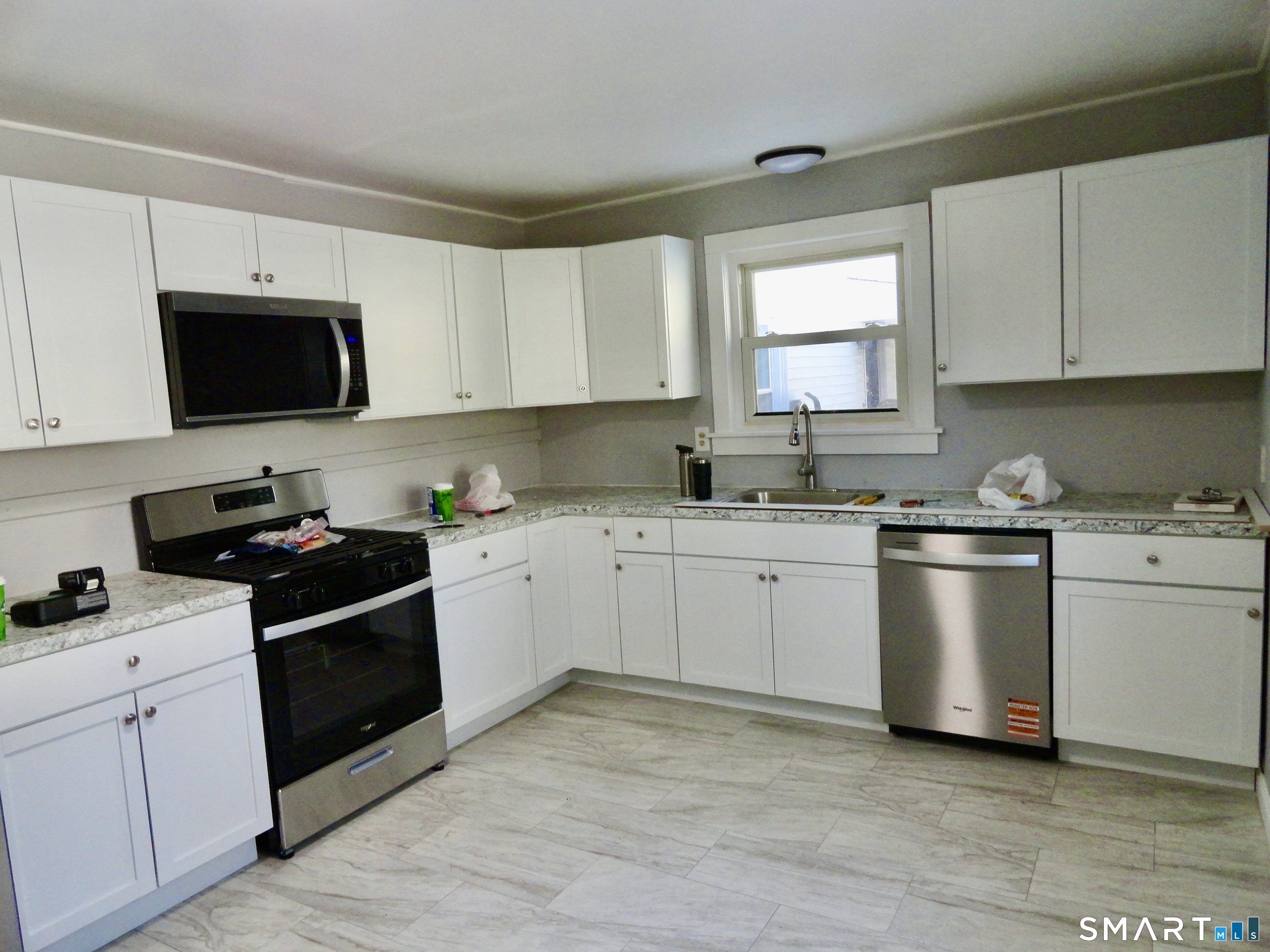 830 Main Street Winsted, CT 06098 - Photo 4 of 17 a kitchen with granite countertop white cabinets and white appliances