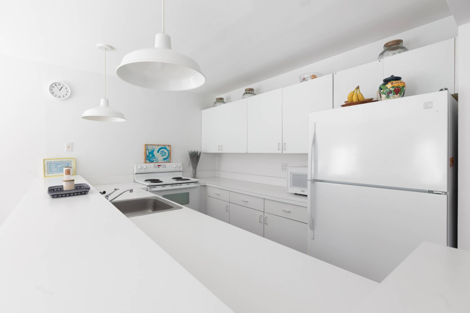 15 North Quarter Road Westhampton, NY 11977 - Photo 11 of 20 a white kitchen with a sink a stove and refrigerator