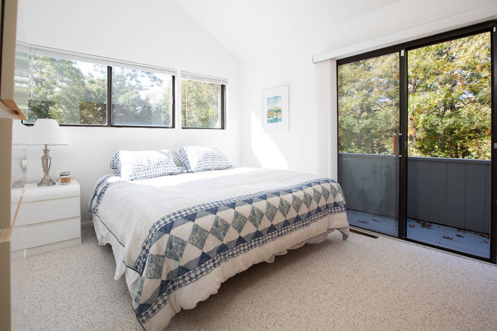 15 North Quarter Road Westhampton, NY 11977 - Photo 16 of 20 a bed sitting in a bedroom next to a window