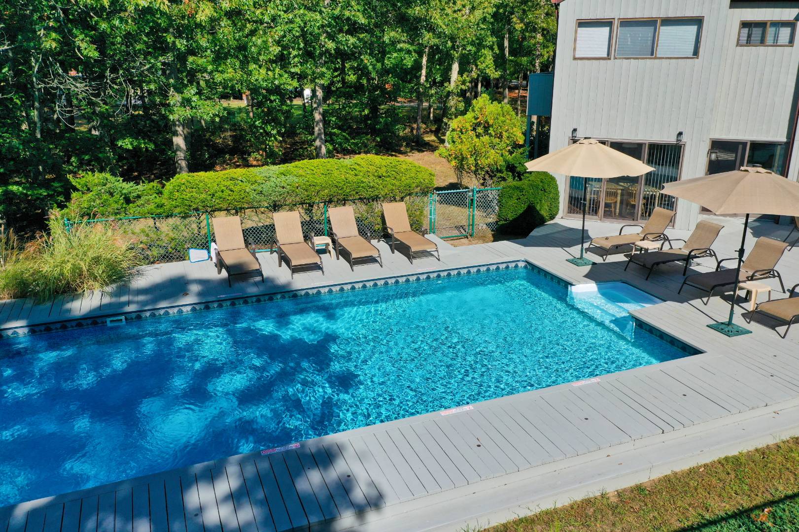 15 North Quarter Road Westhampton, NY 11977 - Photo 4 of 20 a view of a table and chairs under an umbrella