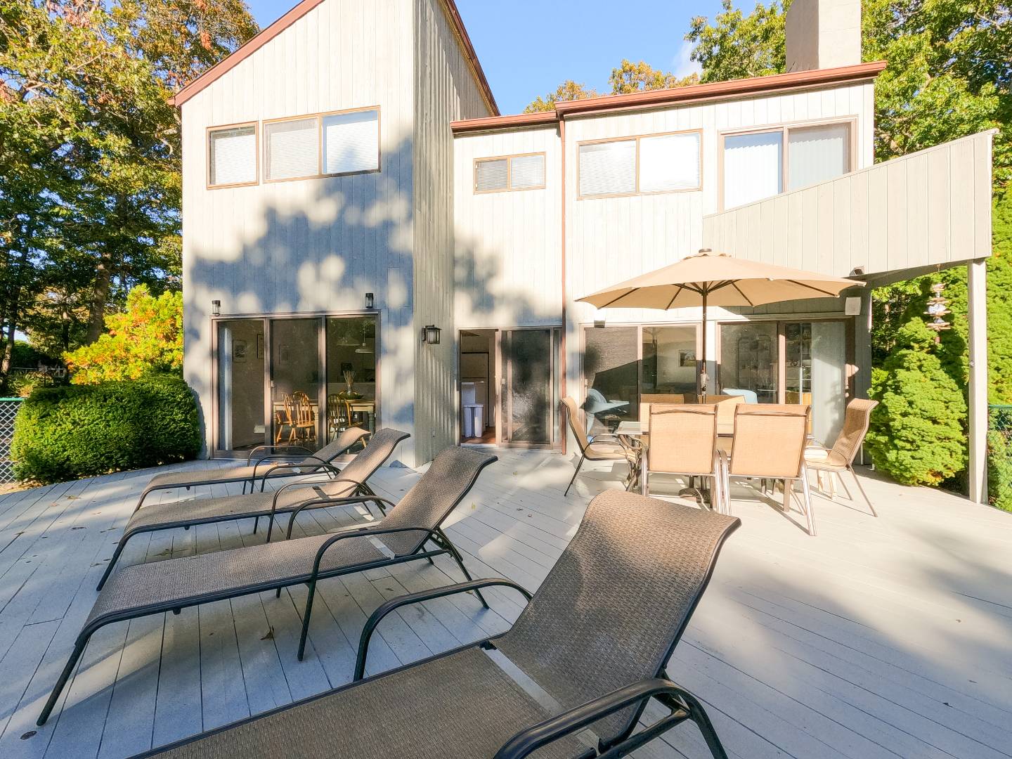 15 North Quarter Road Westhampton, NY 11977 - Photo 7 of 20 a view of a patio with a table chairs and wooden fence