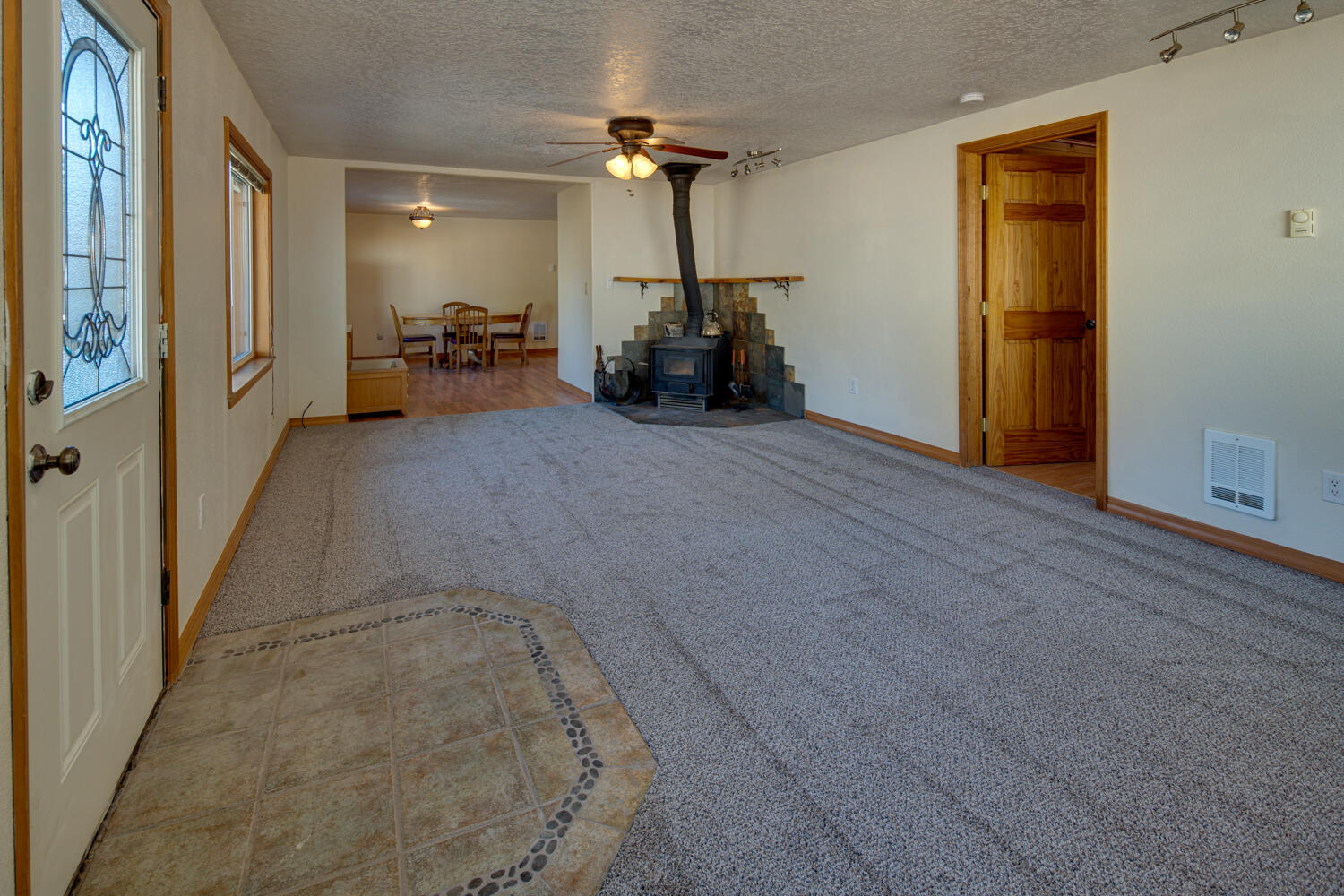 19333 Baker Road Bend, OR 97702 - Photo 10 of 49 Living room with access to the 4th bed/office. New carpet in living room and cozy wood burning stove.