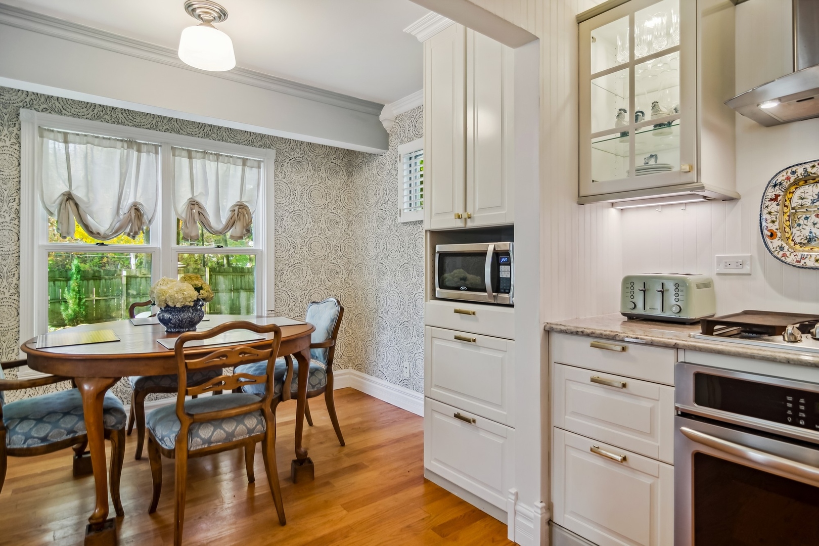 8713 Gardner Road Fox River Grove, IL 60021 - Photo 6 of 25 a kitchen with stainless steel appliances a white table and chairs in it
