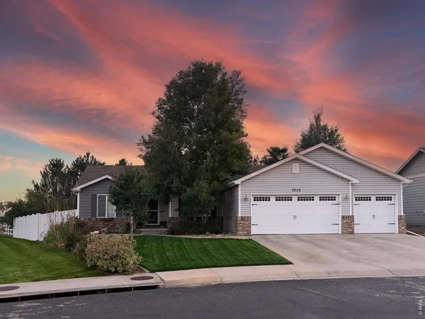 a view of front of house with a yard and garage