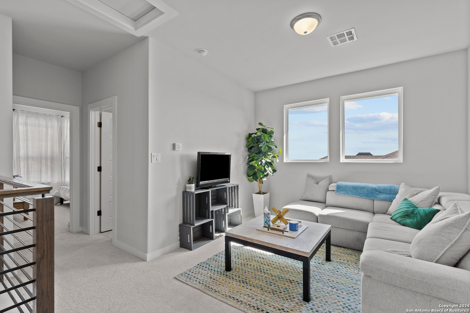 1521 Escarpment Road New Braunfels, TX 78132 - Photo 46 of 65 a living room with furniture a rug and a potted plant