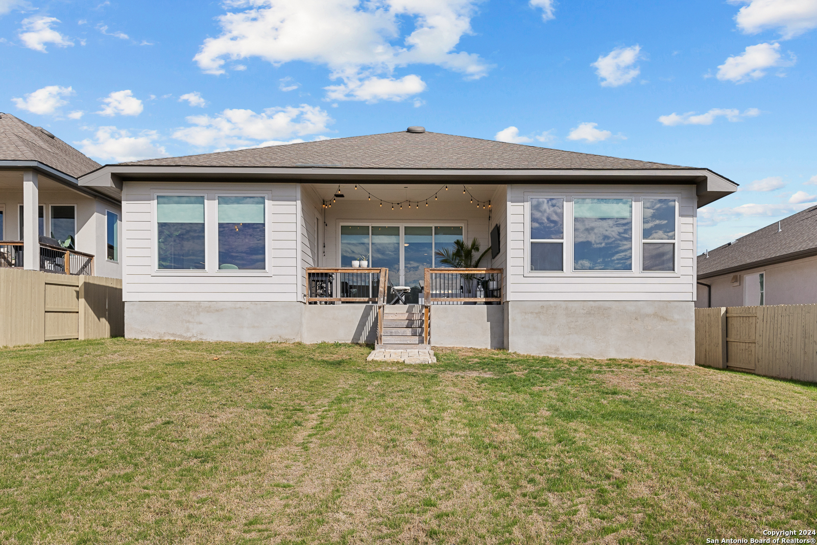 1521 Escarpment Road New Braunfels, TX 78132 - Photo 53 of 65 a view of a house with a backyard and a large tree