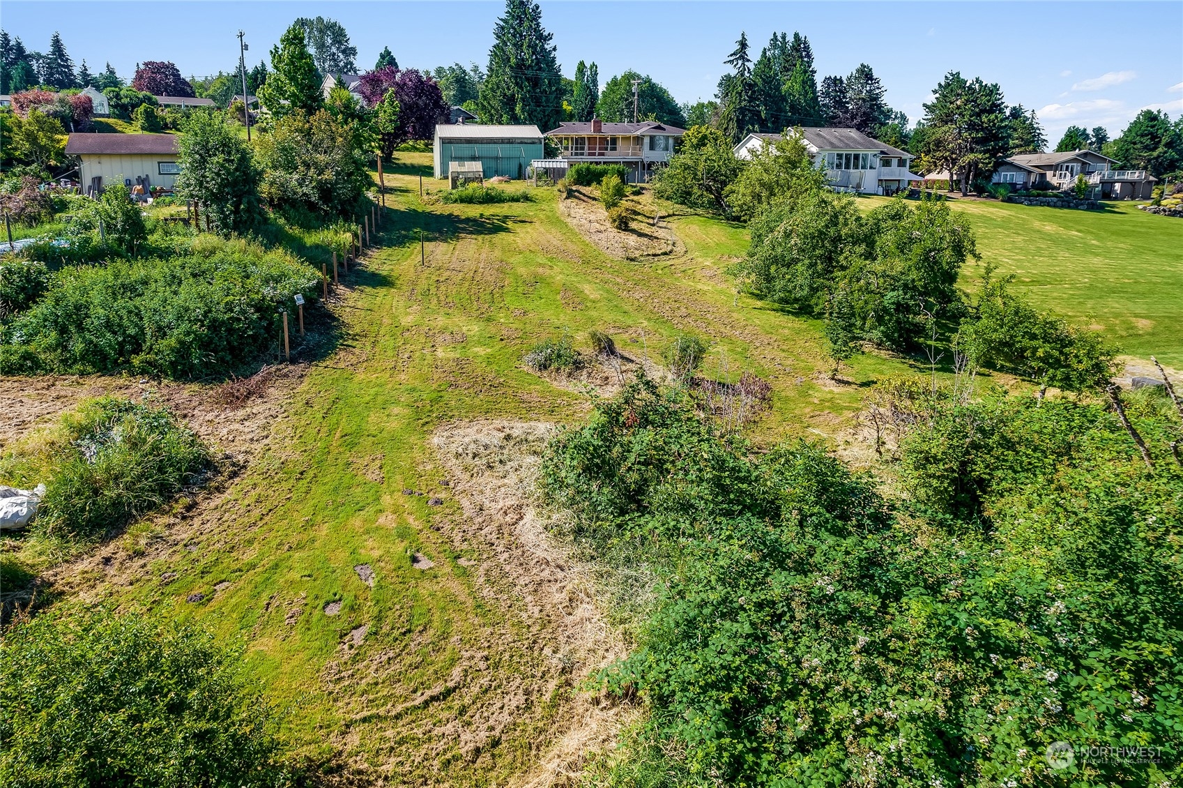6705 Skipley Road Snohomish, WA 98290 - Photo 1 of 40 an aerial view of a house with swimming pool a yard and lake view