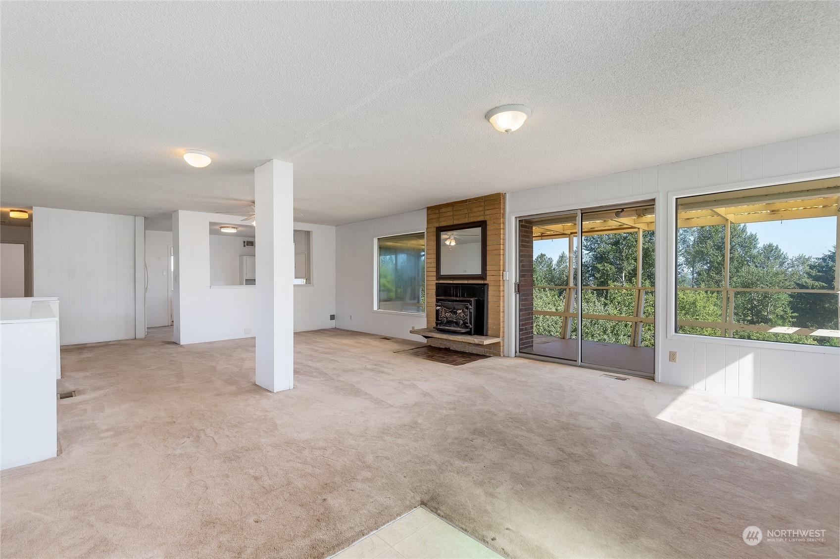 6705 Skipley Road Snohomish, WA 98290 - Photo 4 of 40 a view of a livingroom with an empty space and large windows
