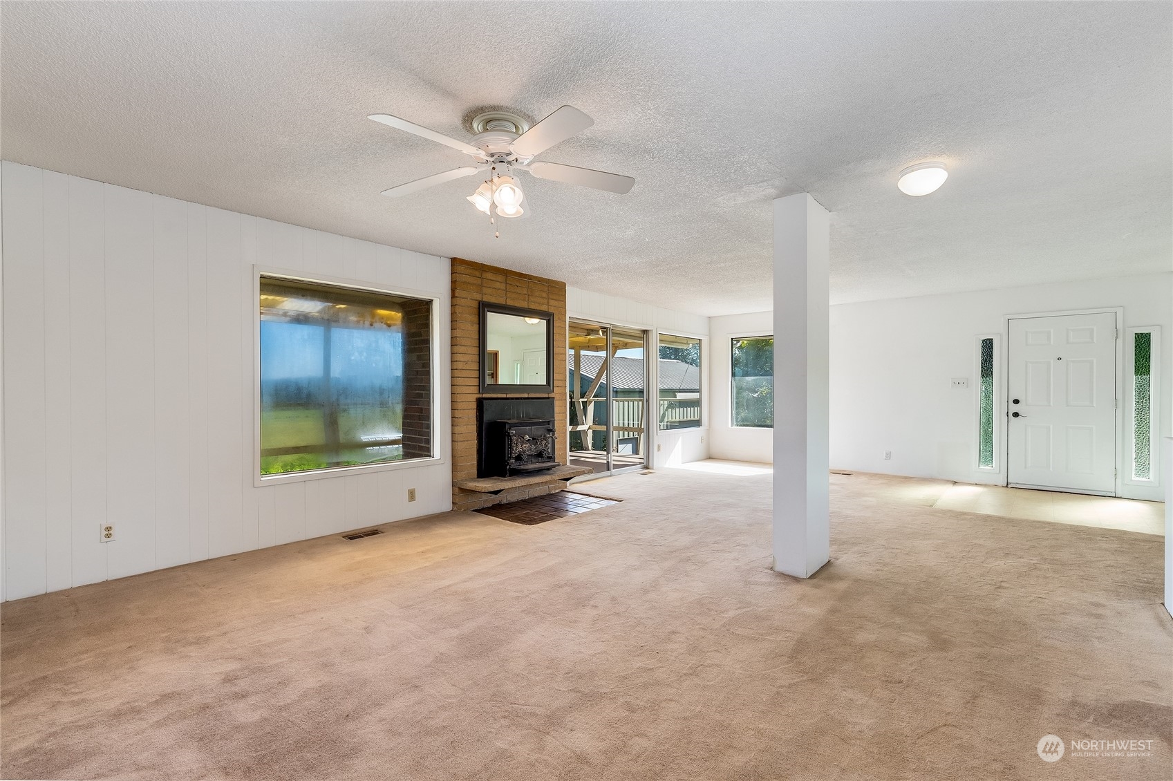 6705 Skipley Road Snohomish, WA 98290 - Photo 5 of 40 an empty room with chandelier fan and windows