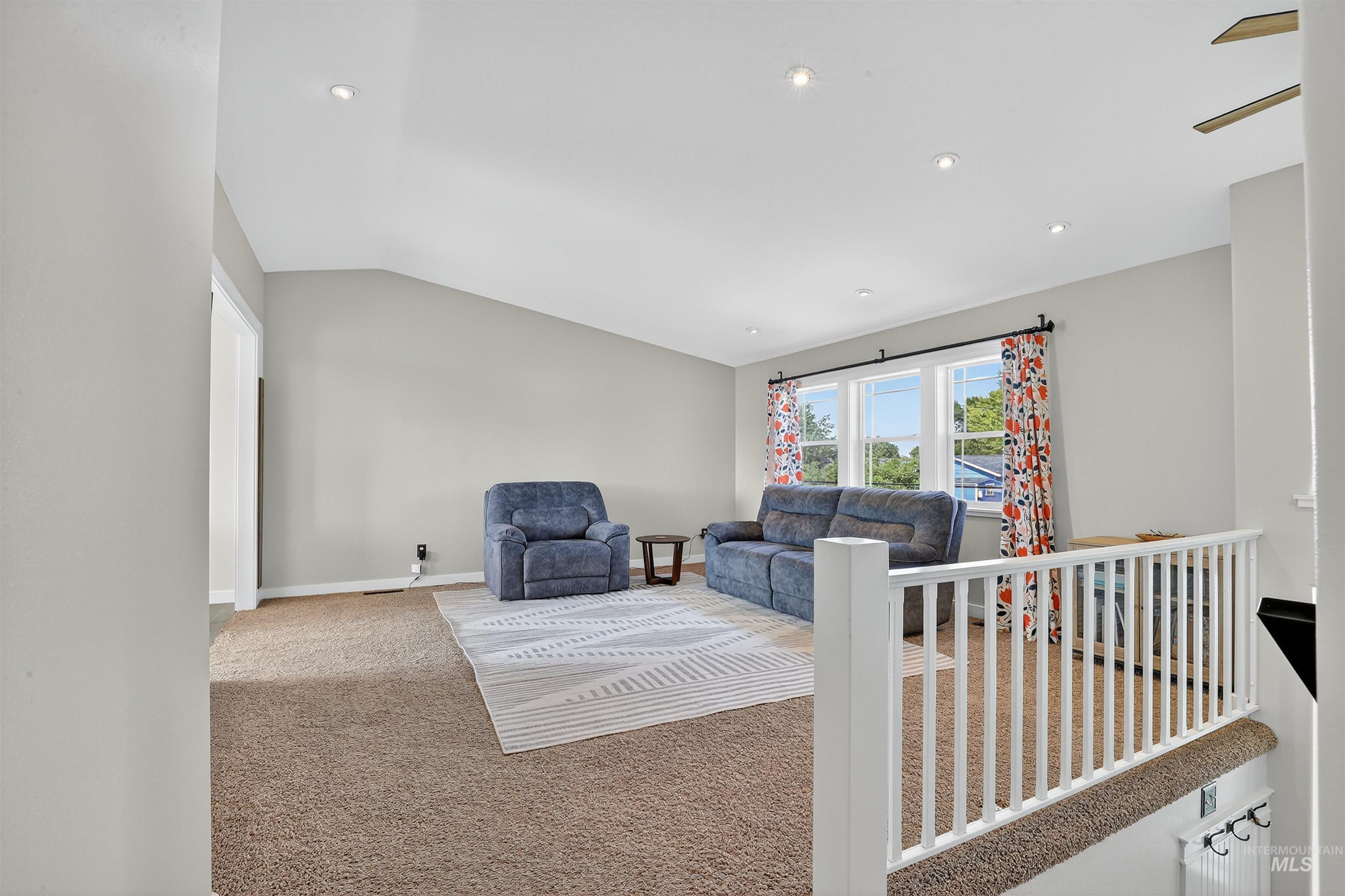 1810 Birch Drive Lewiston, ID 83501 - Photo 13 of 47 Carpeted living area with vaulted ceiling and recessed lighting