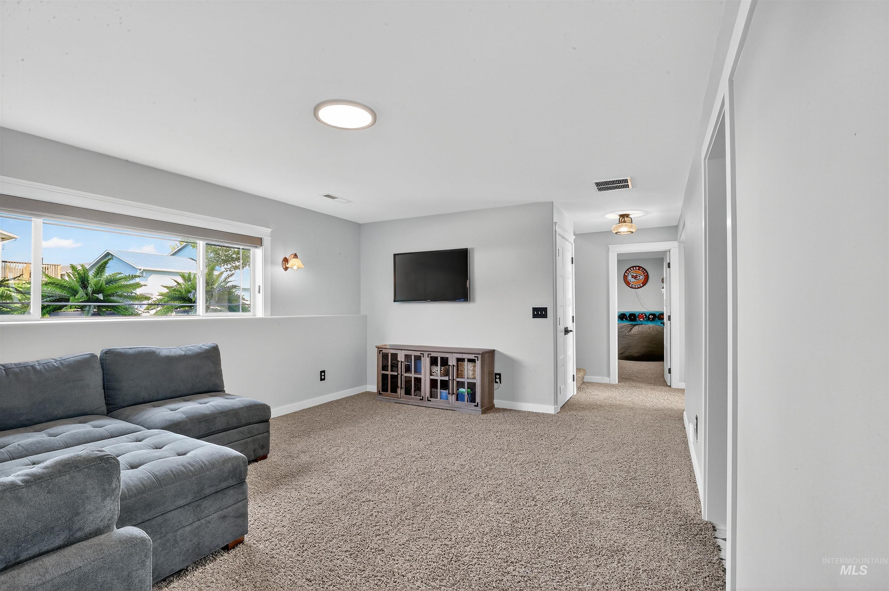 1810 Birch Drive Lewiston, ID 83501 - Photo 27 of 47 Living room with light carpet and baseboards