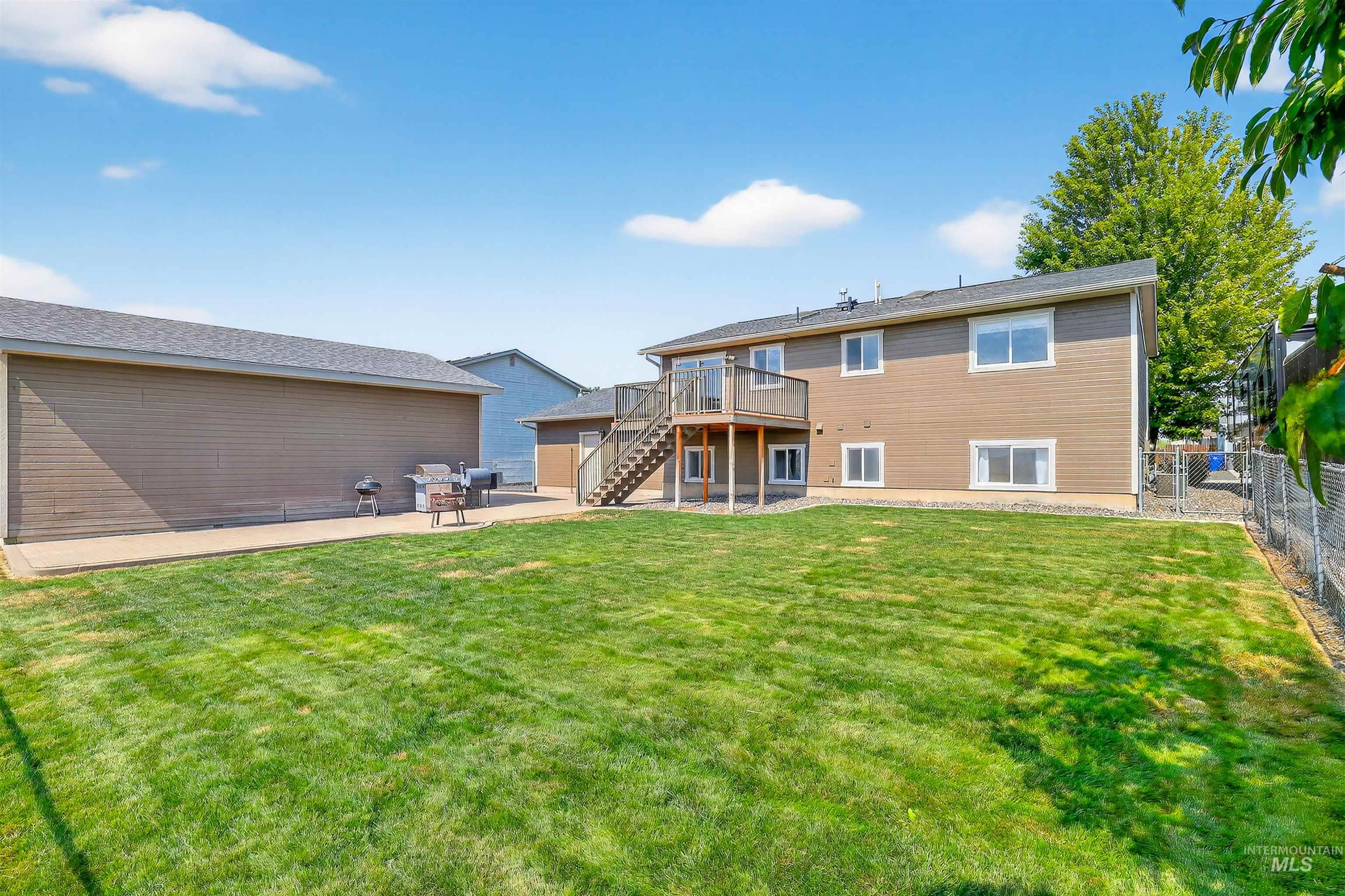 1810 Birch Drive Lewiston, ID 83501 - Photo 41 of 47 Back of property with a patio area, stairway, a deck, and a fenced backyard