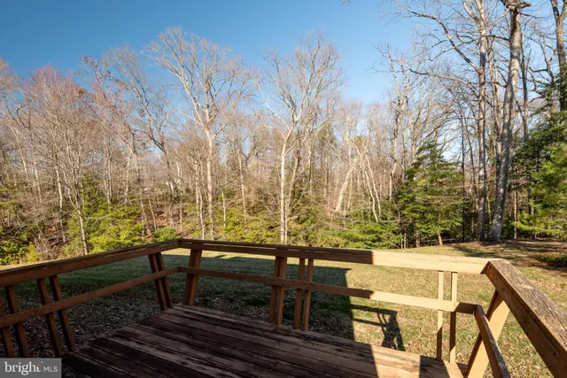 a view of a roof deck with couches and wooden floor