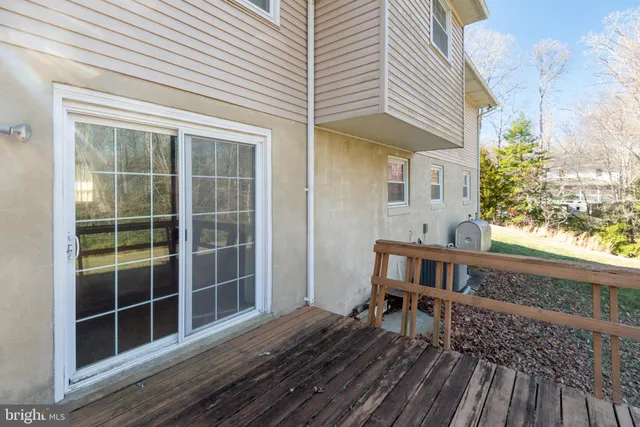 a view of backyard with deck and outdoor seating