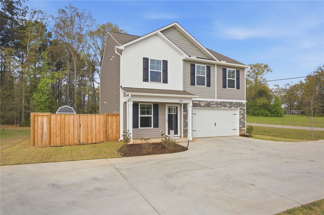 This modern home features a welcoming front entrance and an attached garage.