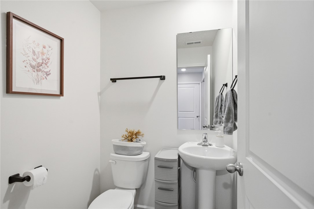 1055 South Depot Street Seneca, SC 29678 - Photo 16 of 43 A well-appointed powder room features a classic pedestal sink and modern fixtures.