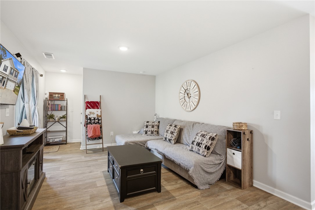 1055 South Depot Street Seneca, SC 29678 - Photo 20 of 43 This inviting space features a modern living room with warm flooring and ample natural light.