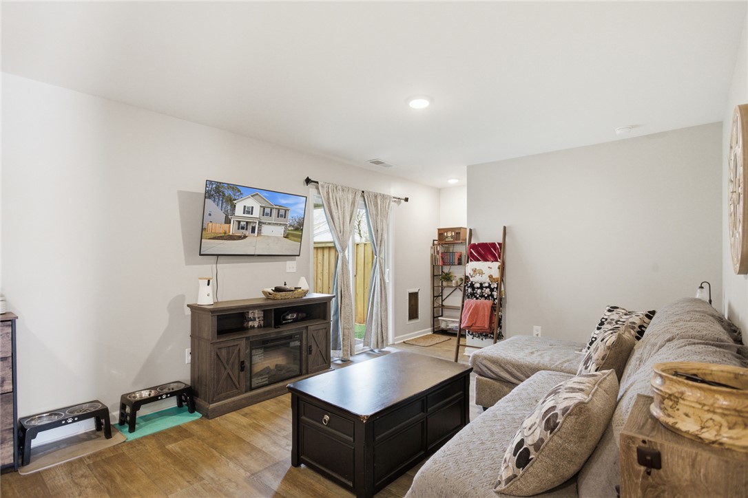 1055 South Depot Street Seneca, SC 29678 - Photo 21 of 43 This living room features rich wood flooring, creating a warm and inviting atmosphere perfect for relaxation.