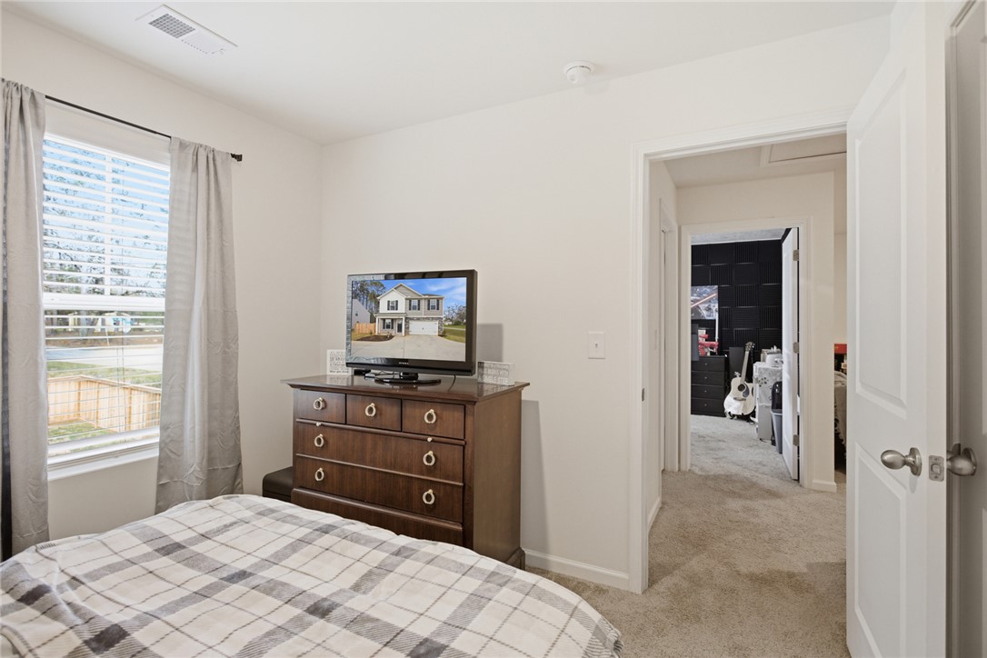 1055 South Depot Street Seneca, SC 29678 - Photo 25 of 43 This cozy bedroom provides a comfortable retreat with soft carpet and a window for natural light.