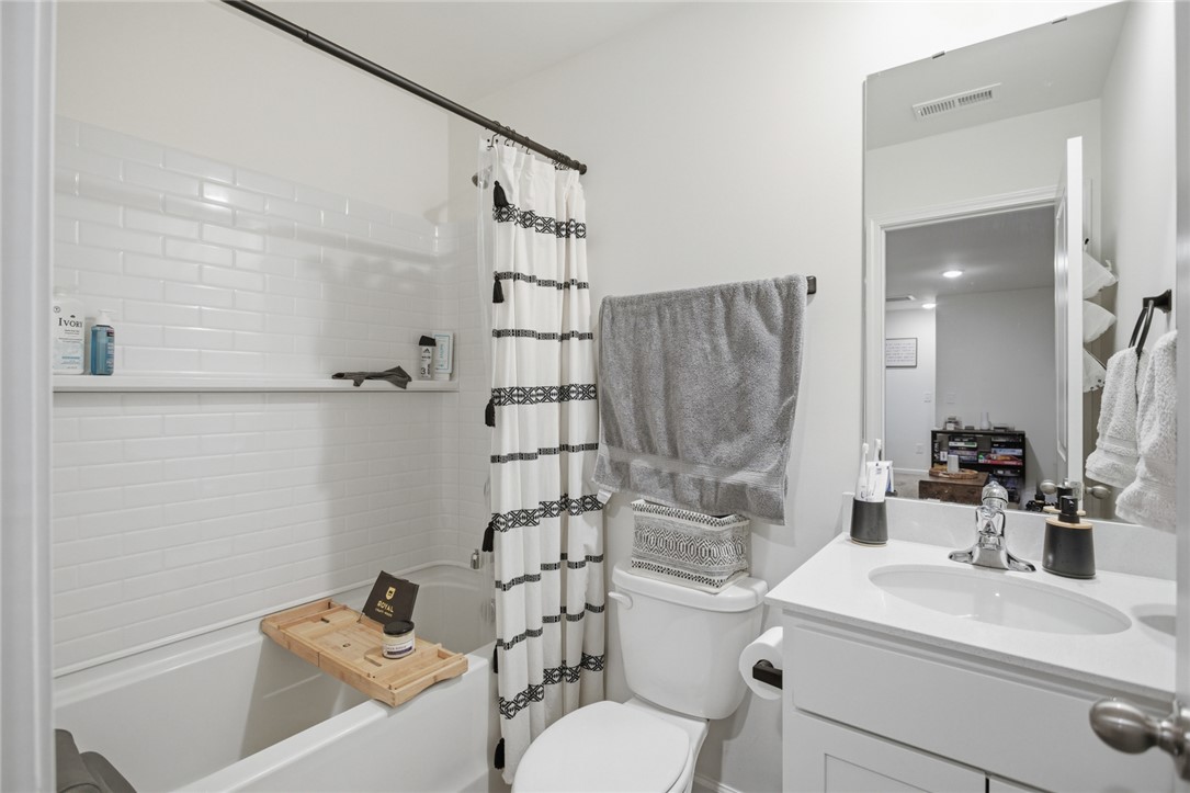 1055 South Depot Street Seneca, SC 29678 - Photo 26 of 43 This bathroom features clean white subway tiles and a practical shower-tub combination.