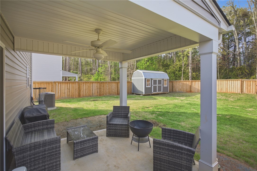 1055 South Depot Street Seneca, SC 29678 - Photo 41 of 43 This backyard features a comfortable patio area with ample space for entertaining and a lush lawn.