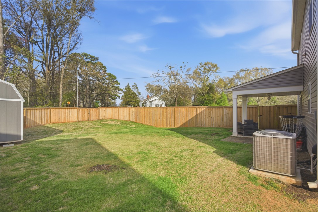 1055 South Depot Street Seneca, SC 29678 - Photo 42 of 43 This spacious backyard features a privacy fence and a charming covered patio.