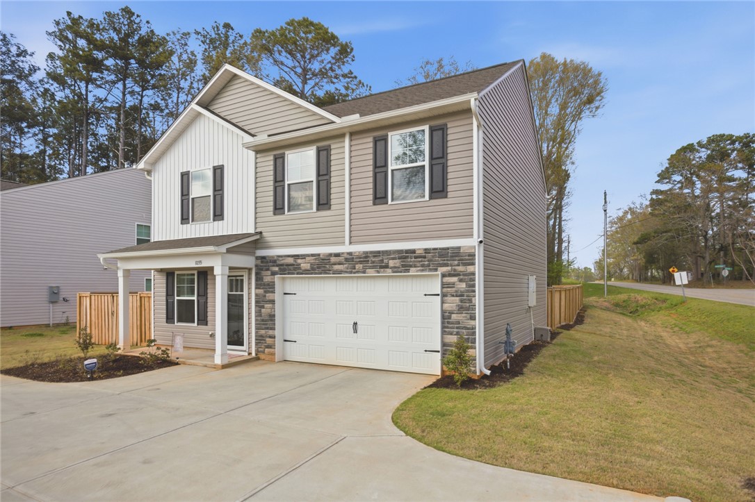 1055 South Depot Street Seneca, SC 29678 - Photo 5 of 43 This charming home offers a convenient attached garage and a welcoming front porch.