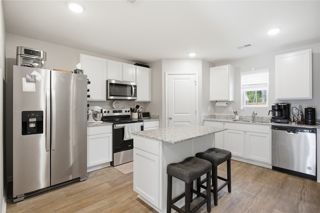 1055 South Depot Street Seneca, SC 29678 - Photo 8 of 43 This kitchen showcases ample cabinet space, a practical island, and modern stainless steel appliances.