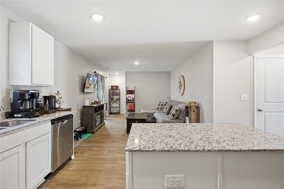 1055 South Depot Street Seneca, SC 29678 - Photo 10 of 43 An inviting open-concept living space features a kitchen island, hardwood floors, and abundant recessed lighting.