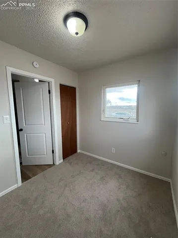 an empty room with a empty space and windows