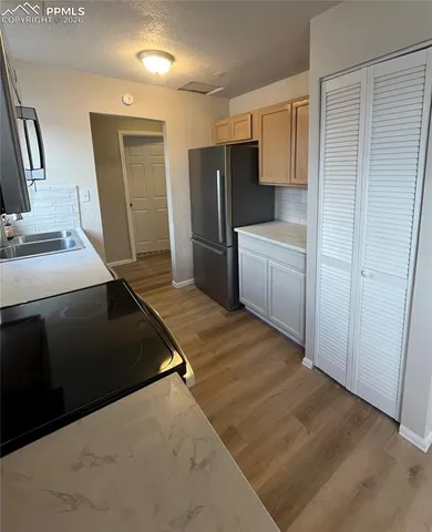 a kitchen with a sink stove and refrigerator
