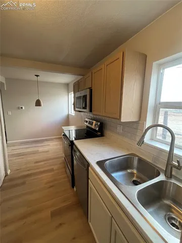 a kitchen with a sink and cabinets