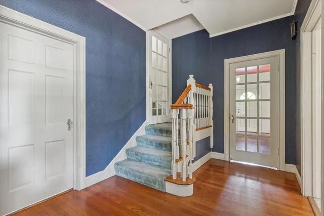 an entryway of a house with wooden floor windows and entryway