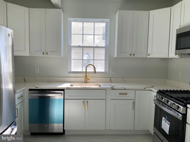 a kitchen with a sink stove and cabinets