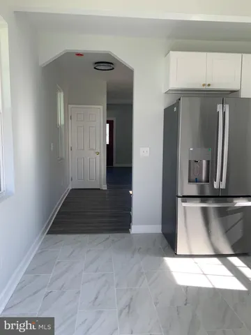 a view of a kitchen with white cabinets