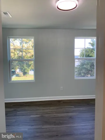 an empty room with wooden floor