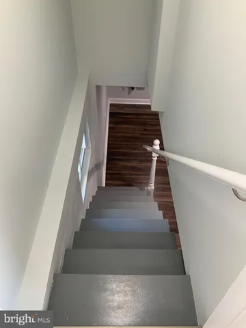a view of a room with wooden floor and stairs