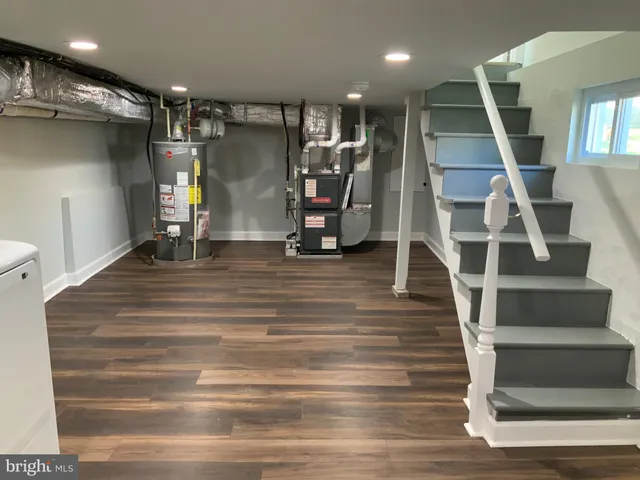 a view of a hallway with entryway and wooden floor
