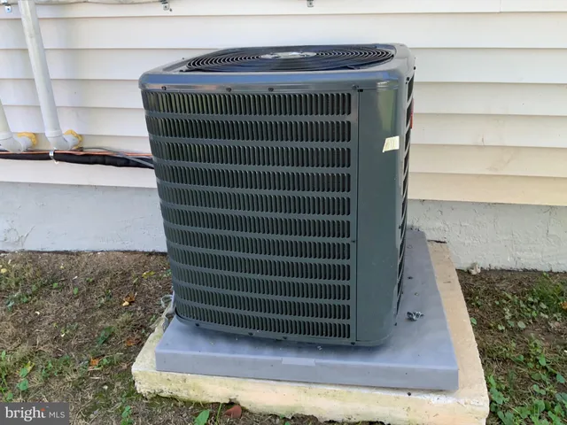 a view of a house with backyard and wooden fence