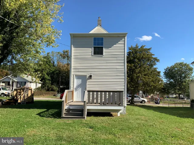 a view of backyard with a garden and deck