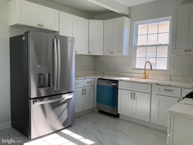 a kitchen with stainless steel appliances granite countertop a refrigerator sink and cabinets