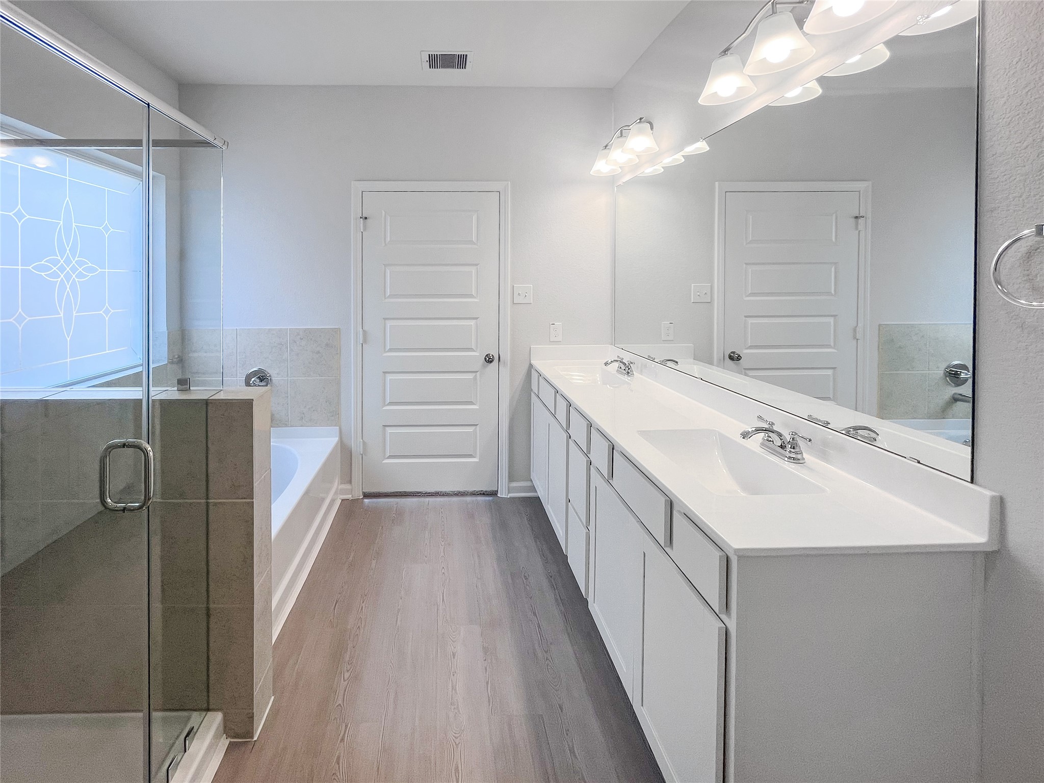 9717 Enclave Ridge Road Willis, TX 77318 - Photo 11 of 20 The Waring III- Primary Bathroom with Dual Vanities, Separate Garden tub and Walk-in Shower. Sample image for illustration; upgrades, options, and colors may vary.