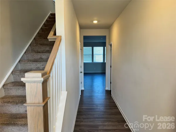 an empty room with wooden floor and fireplace