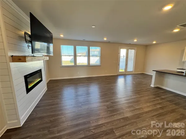 a open kitchen with kitchen island wooden floors and stainless steel appliances