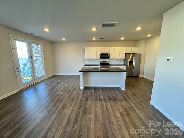 a kitchen with stainless steel appliances granite countertop a sink microwave and stove